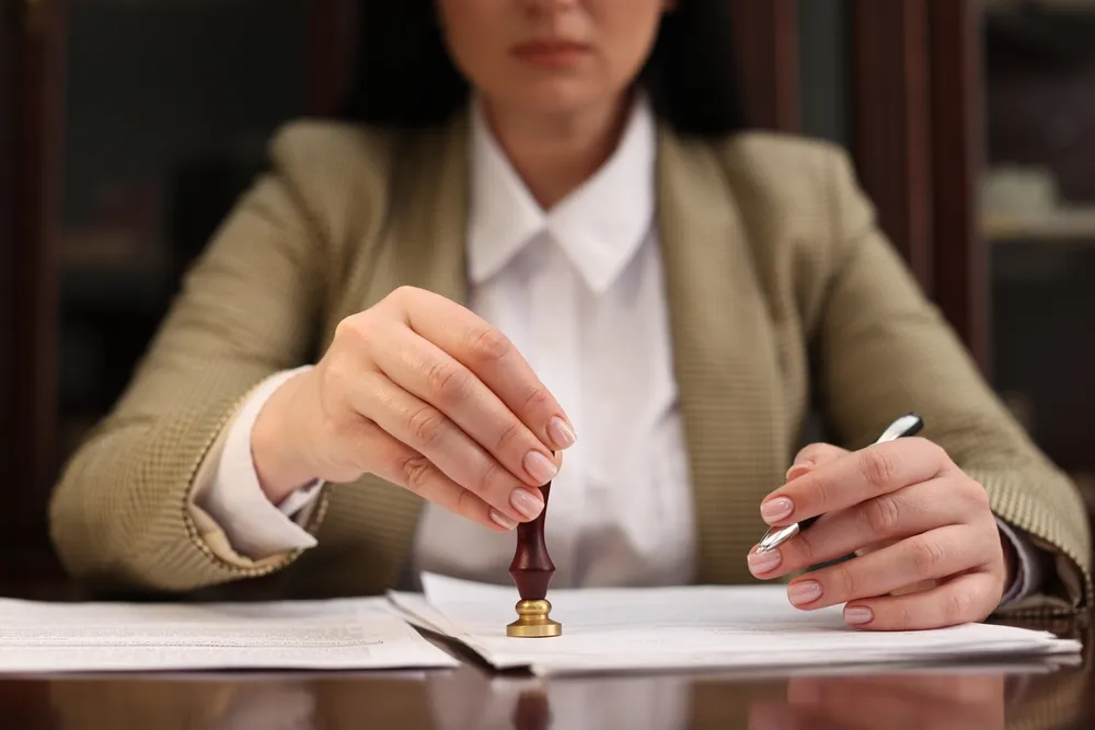 A notary public stamping documents | Bhavini S Law