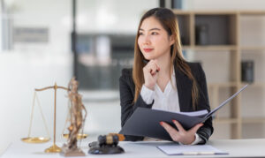 Female lawyer reviewing estate files related to letters of administration in Singapore.