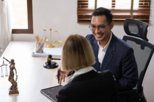 A lawyer discussing a lasting power of attorney in Singapore with a client in an office setting.