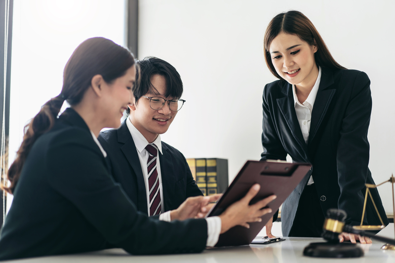 A legal team reviewing documents related to a lasting power of attorney in Singapore with a client.